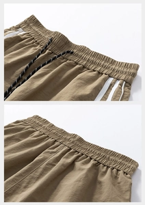 Dettagli dei pantaloncini sportivi marroni con elastico in vita e strisce laterali
