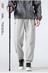 Close-up of lightweight hiking pants showing windproof fabric and zipper pocket detail