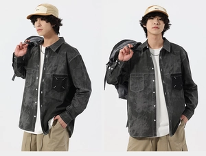 Detail of dark grey washed denim shirt featuring white contrast stitching and pocket embroidery