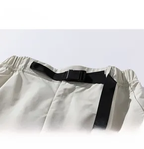 Detailed view of elastic waistband with adjustable nylon belt and buckle on cargo shorts