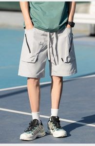 Detail of light grey cargo shorts with zipper pockets and breathable quick-dry fabric