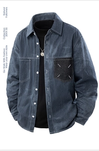 Detail view of retro denim shirt featuring contrast pocket with white cross stitching