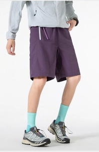 Detail shot of purple quick-dry shorts featuring textured fabric and decorative waist belt