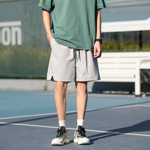 Athletic grey drawstring shorts for men featuring lightweight breathable fabric in outdoor style