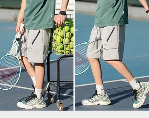 Detail of light gray tactical sports shorts featuring side zip pockets and drawstring waist