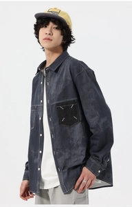 Detail of dark grey washed denim shirt featuring white contrast stitching and pocket