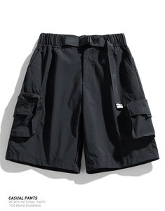 Detail view of black water-repellent cargo shorts with elastic waist and buckle belt