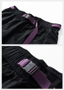 Detail of black tactical shorts featuring elastic waist and vibrant purple buckle belt