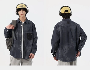 Detail view of washed denim shirt featuring signature white contrast stitching on the pocket