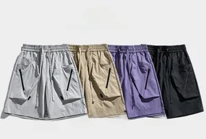 Macro view of drawstring waist and multi-color cargo shorts with zipper utility pockets