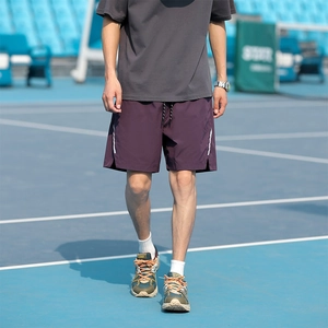 Men's purple sporty cargo shorts with side stripes on a blue tennis court setting