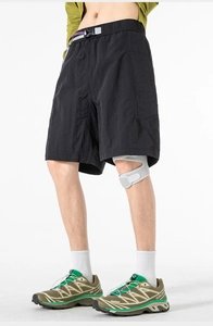 Detail of black quick-dry utility shorts with purple strap and quick-release buckle