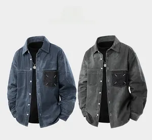 Detail view of denim shirts with contrast chest pockets and distinctive X-shaped stitching