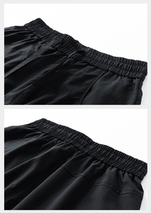 Detail of black sports shorts featuring elastic waistband with adjustable drawstring