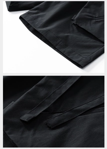 Detail view of reinforced stitching and durable tactical webbing on black cargo shorts