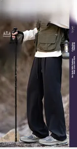 Outdoor quick-dry hiking pants with drawstring waist shown in a mountain camping scenario