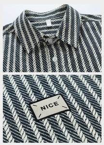 Close-up of jacquard denim shirt texture with a 'NICE' rectangular label and white buttons