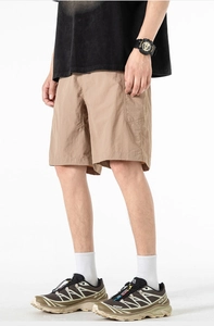 Close-up of khaki quick-dry cargo shorts featuring side pockets and textured fabric