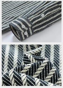 Macro detail of black and white herringbone denim jacquard fabric with triple buttoned cuffs