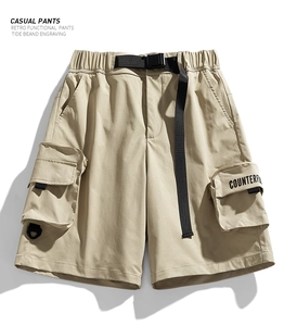 Detailed view of khaki water-repellent cargo shorts featuring a functional buckle belt
