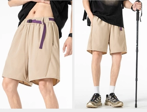Detail of khaki cargo shorts with adjustable purple buckle belt and elastic waistband