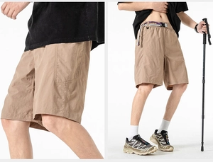 Detail of khaki quick-dry cargo shorts with adjustable purple and grey buckle belt