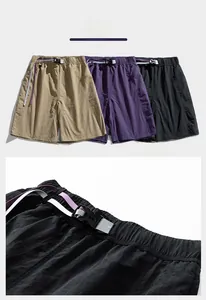 Detail of quick-dry cargo shorts featuring an elastic waist and multi-color buckled belt