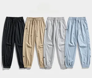 Detail view of elastic waist and zipper pockets on outdoor hiking cargo pants