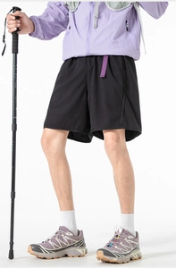 Detail of black quick-dry outdoor shorts with contrasting purple woven belt and tech fabric