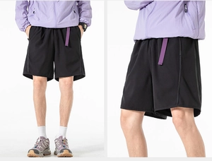 Detail of black sports shorts featuring purple belt and breathable quick-dry fabric