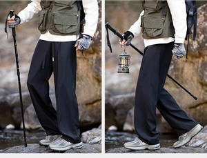 Detail view of black hiking trousers with elastic drawstring and breathable fabric