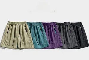 Detail of cargo shorts in multiple colors showing elastic waistband and zipper pockets