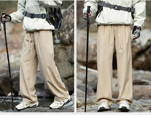 Outdoor khaki hiking pants with drawstring waist and straight leg cut shown in nature scene