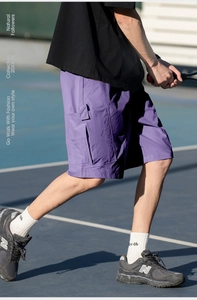 Detail of purple cargo shorts featuring large utility 3D pockets and tactical nylon fabric