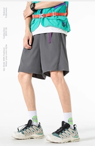 Detailed side view of dark grey city boy cargo shorts featuring purple webbing accents