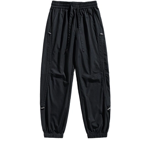 Outdoor leisure hiking pants in black with elastic drawstring waist and zipper pockets
