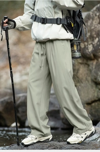 Close-up of lightweight hiking trousers with adjustable drawstring waist for camping