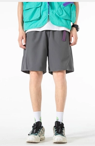 Detail of dark gray quick-dry cargo shorts in a modern outdoor utility style