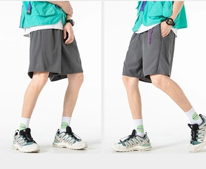 Detail view of charcoal grey urban outdoor shorts with elastic waist and purple strap
