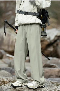 Close-up of quick-dry hiking pants with drawstring waist in an outdoor camping setting