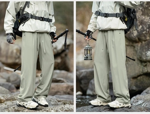 Detail of grey-green outdoor hiking pants showing straight-leg fit and drawstring waist