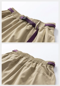 Detail view of khaki cargo shorts waist with purple nylon webbing and plastic buckle