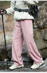 Detail of pink quick-dry hiking pants with drawstring waist and metallic side buckles