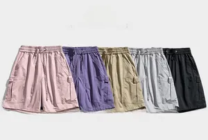 Flat lay detail showing five colors of mens cargo shorts with elastic drawstring waist