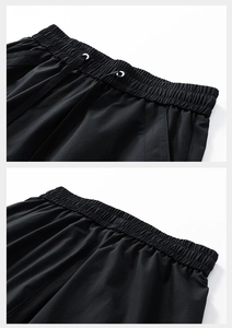 Detail of elastic waistband with drawstring and metal eyelets on black cargo shorts