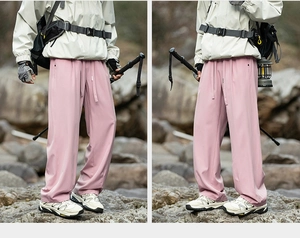 Detail of light pink hiking trousers with adjustable drawstring waist for outdoor use