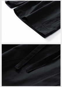 Detail shot of black cargo shorts showing reinforced stitching and cotton texture
