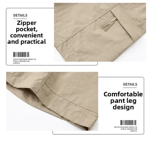 Detail view of khaki cargo shorts showing zipper side pocket and hem stitching