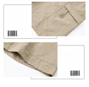 Detail of khaki cargo shorts showing zipper flap pocket and durable double-stitched hem