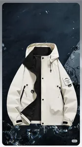 Close-up of beige waterproof outdoor jacket featuring zip pockets and mountain arm patch